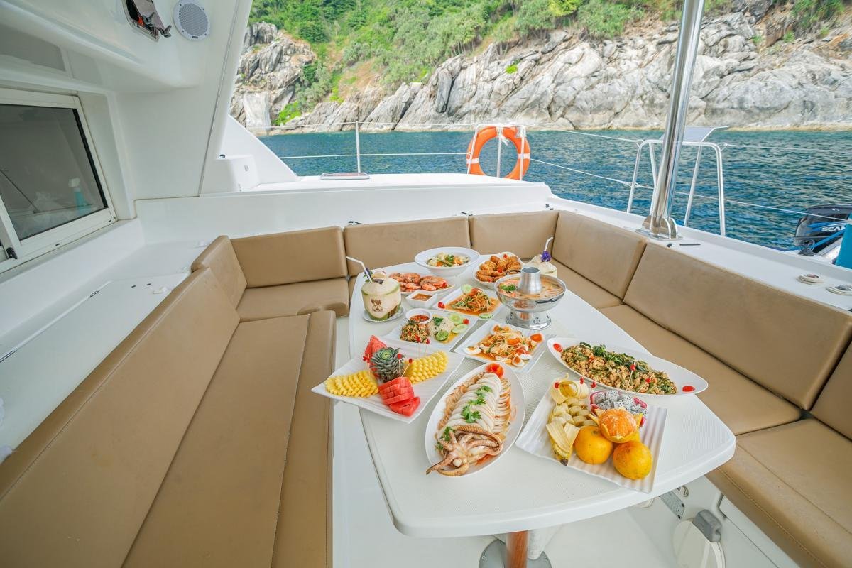 A yacht anchored off a limestone island in the Andaman Sea